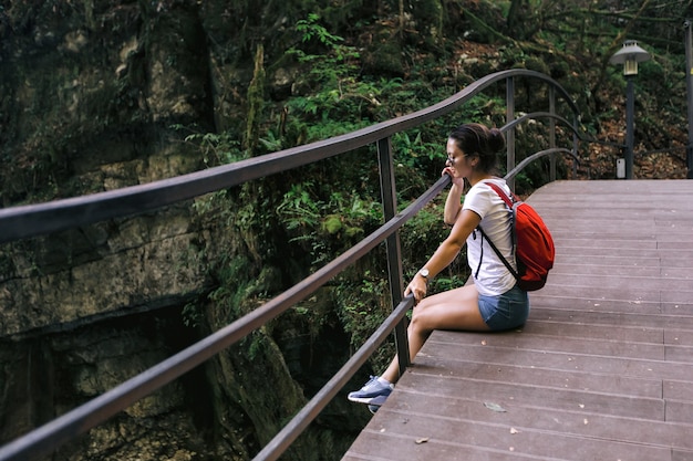 Female tourist with backpack walking in park