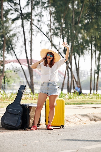 Female traveler trying to chatch car