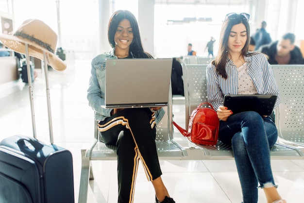 Female travelers waiting for departure in airport