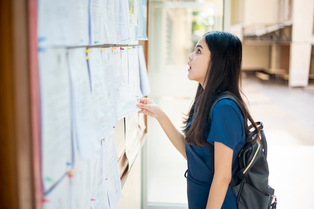 A female university student is exciting with the exam report