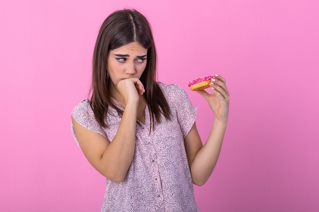 Photo female using hand push out her favourite donut for good health.