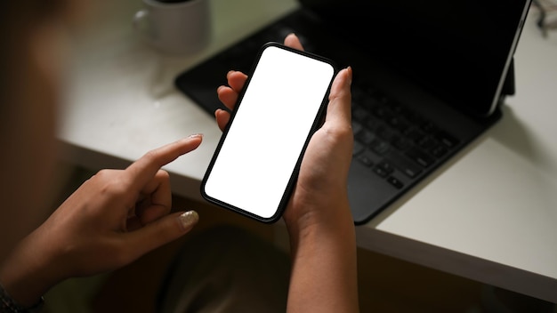 Female using smartphone over her office desk smartphone white screen mockup Chat Message Text