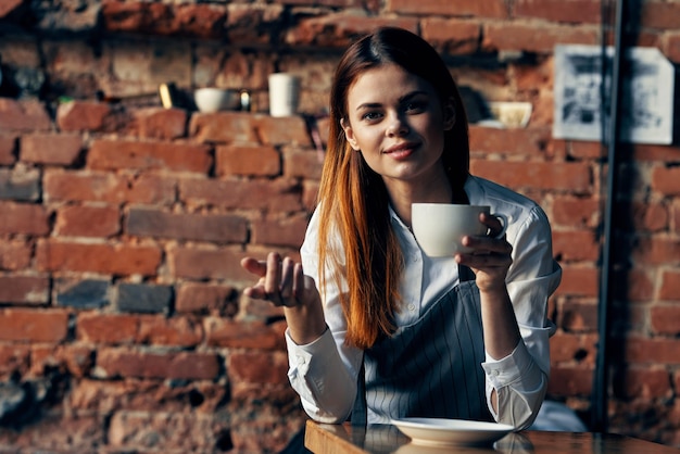 Female waiter in apron coffee cup service ordering