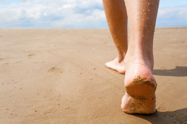 Female, walking down the beach.