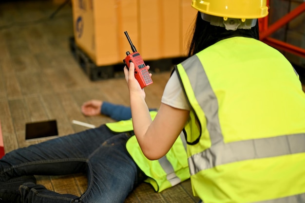 A female warehouse worker rescue an unconscious man in the warehouse