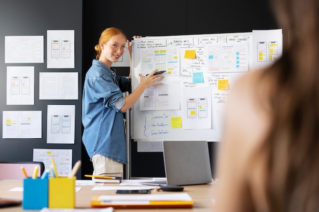 Female web designer with papers and notes in the office
