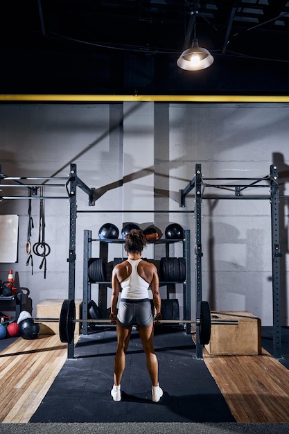 Female weightlifter working out at the gym