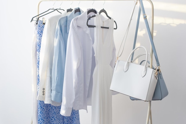 Female white and blue capsule summer wardrobe in white room