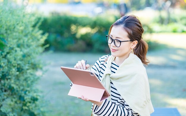 Female with black rimmed glasses outdoors