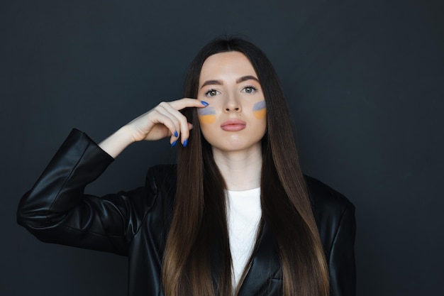 female with flag of Ukraine on her cheek National symbol of freedom and independence