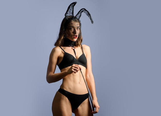Female with sexy ass posing wearing bunny ears on Easter day. Rabbit easter. Sexy brunette posing nude wearing bunny ears. Bikini model.