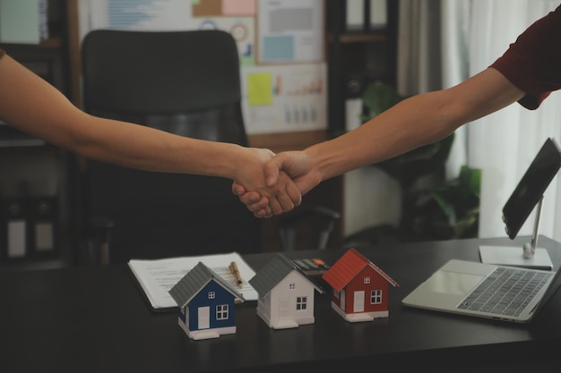 Female woman hands holding home model small miniature white toy house Mortgage property insurance dream moving home and real estate concept