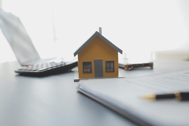 Female woman hands holding home model small miniature white toy house Mortgage property insurance dream moving home and real estate concept