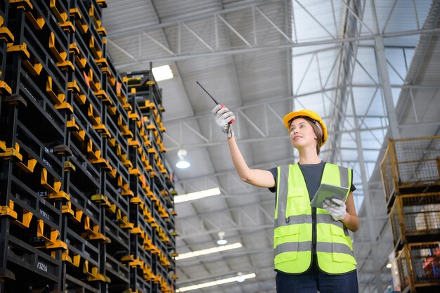 Female worker in an auto parts warehouse Examine auto parts that are ready to be shipped