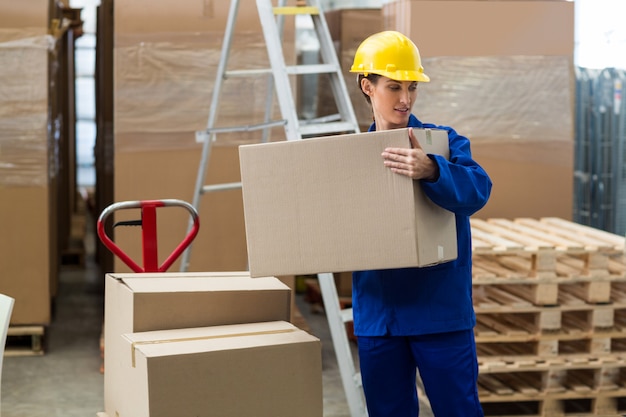 Female worker carrying a box