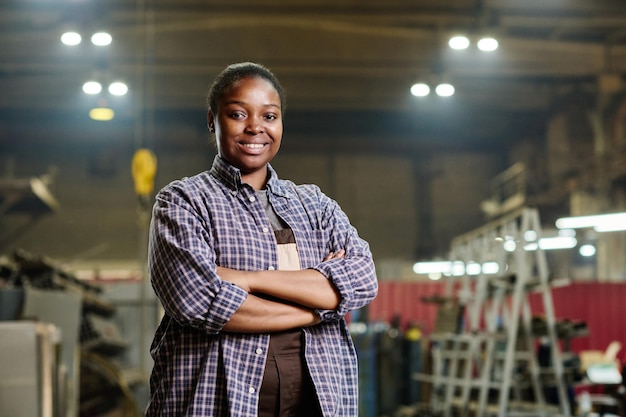 female worker standing in factory workshop