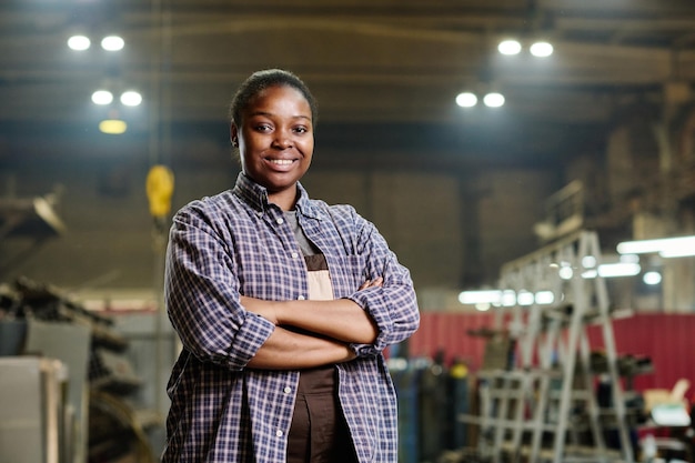 Female worker standing in factory workshop