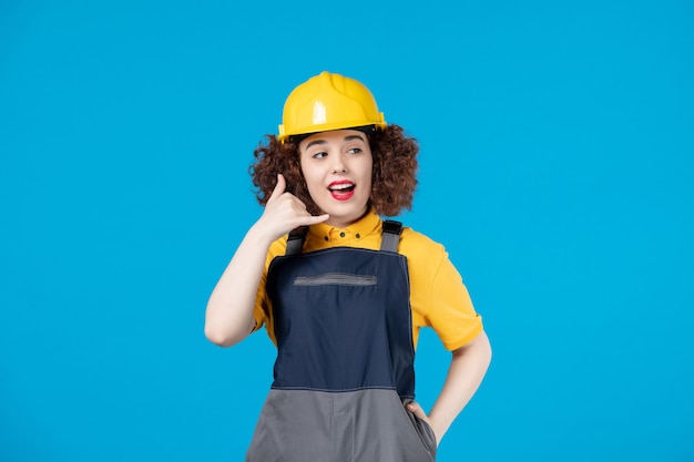 Female worker in yellow uniform on blue