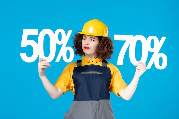 Female worker in yellow uniform with and signs on blue