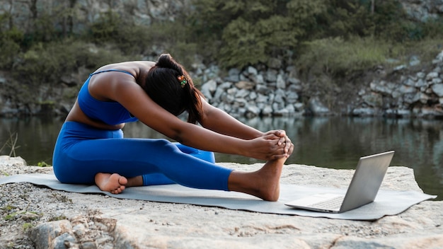 Female yoga teacher teaching online