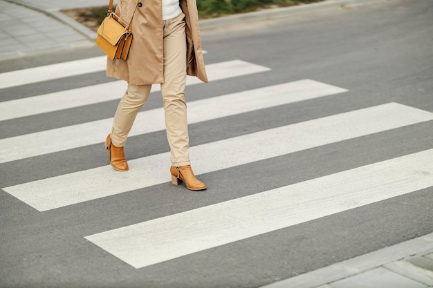 Female39s legs in heels crossing a road downtown