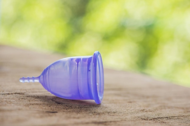 Feminine hygiene product - Menstrual cup On a wooden background