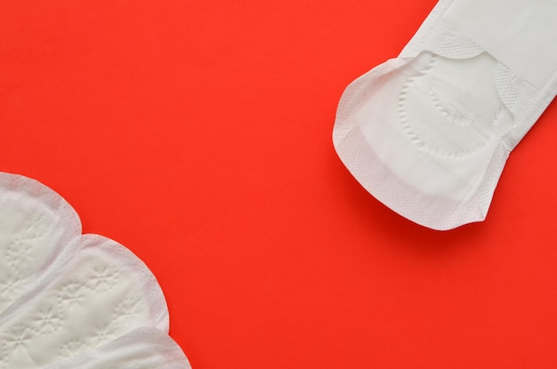 Feminine hygiene products pads on a red background space for object