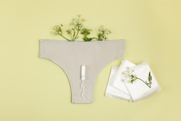 Photo feminine hygiene products and panties on a light background