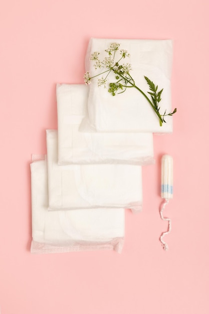 Feminine hygiene products on pink background