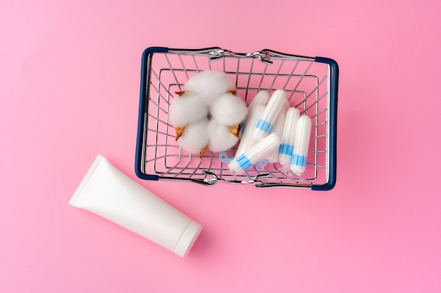 Feminine hygienic tampons on pink paper background