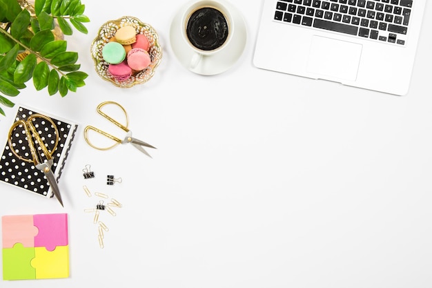 Feminine office desk workplace Coffee cookies laptop plant