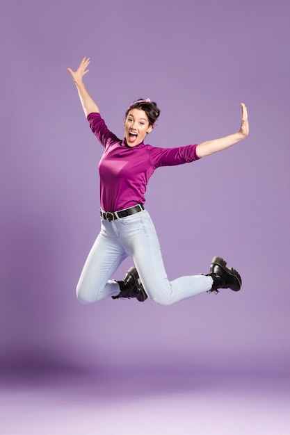 Photo feminist woman jumping and stretching her arms