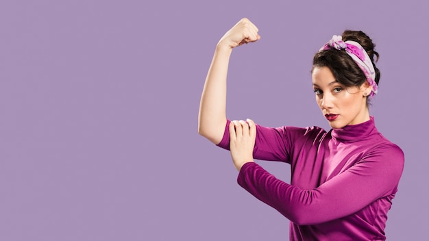 Feminist woman showing her power and copy space background