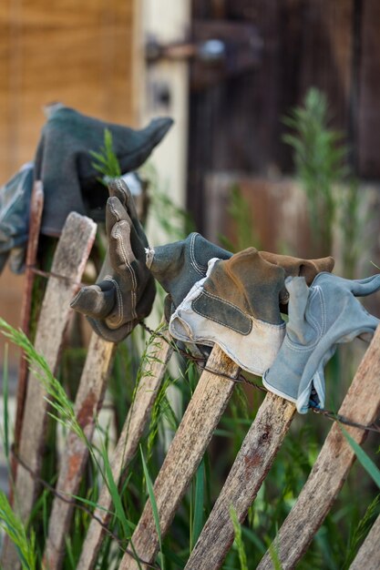 Fence decorated with old work gloves.