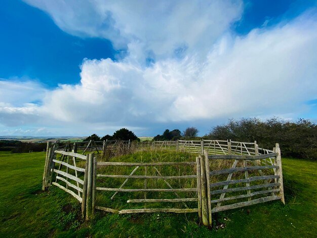 Fence on field against sky