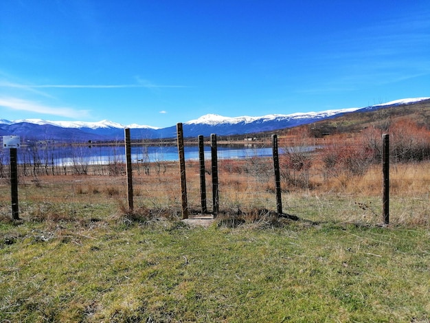 Fence on field against sky