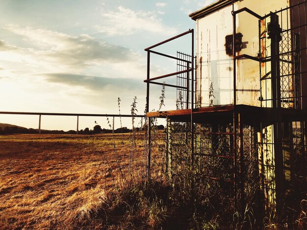 Fence on field against sky