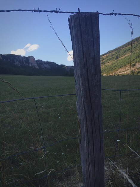 Foto recinzione su un campo erboso contro il cielo