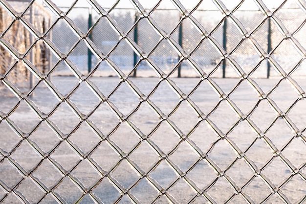 The fence is covered with ice after freezing rain