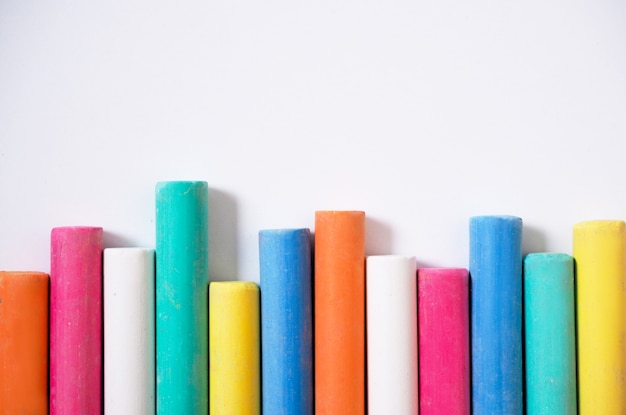 Fence of multicolored chalk on paper for art.