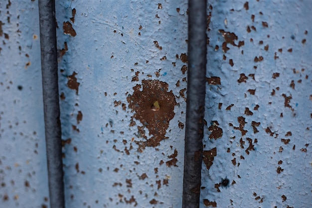 Photo fence near the house with bullet holes and charapnels after gunshots and fighting during the invasio