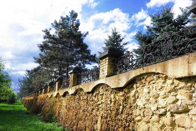 Fence placed a long brick wall.