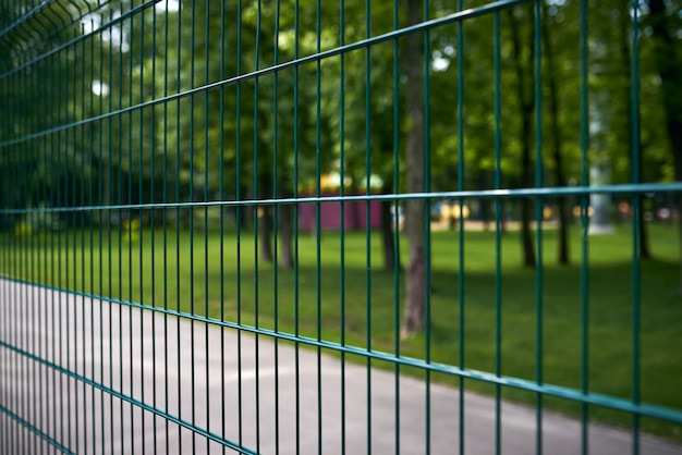 Fence at the public park at summer day