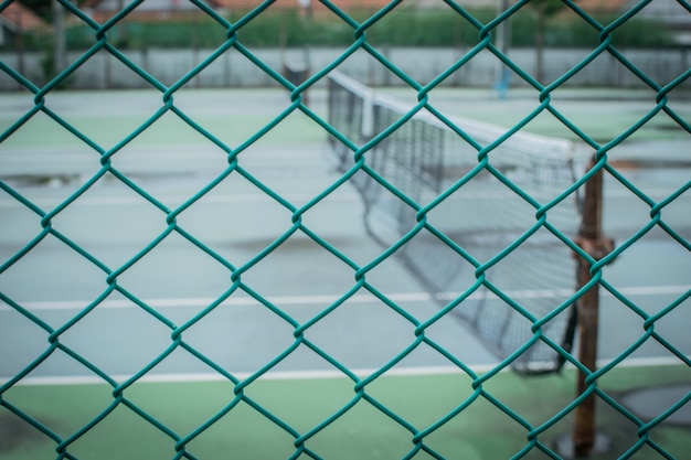 fence and tennis court. Focus on the foreground