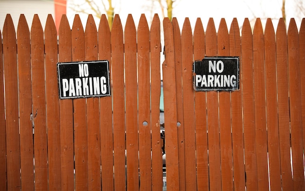 A fence with a no parking sign on it