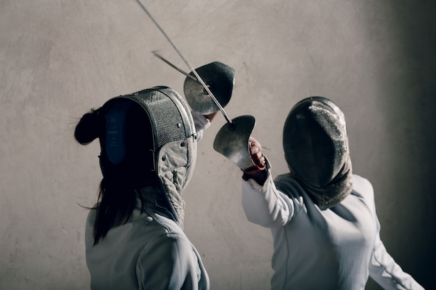 Fencers duel with fencing sword.