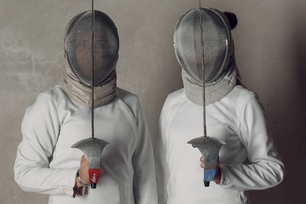 Fencers women with fencing sword.