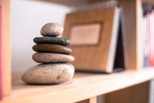 Feng Shui Stone cairn in a book shelf in the living room balance and relaxation