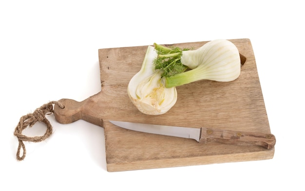 Fennel bulb isolated on a wooden cutting board on a white background