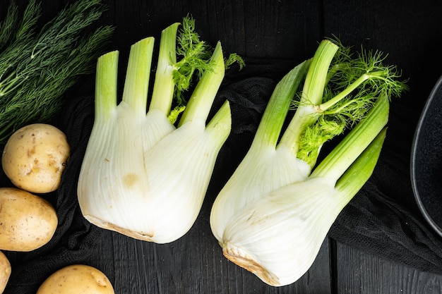 Fennel bulbs, on black wooden table, flat lay